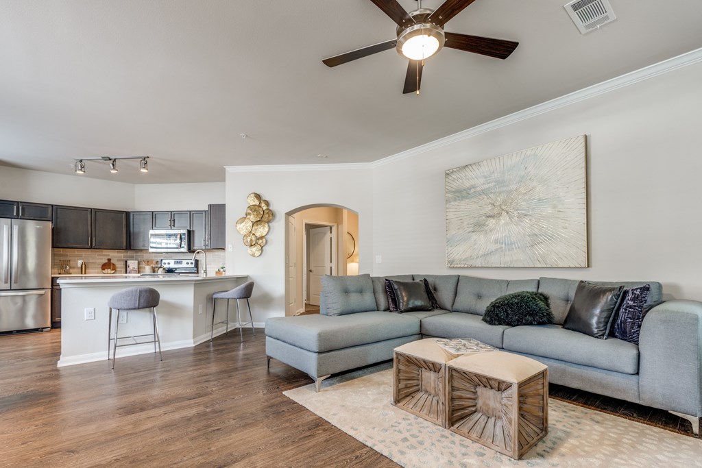 A living room with a grey couch and a wooden coffee table.