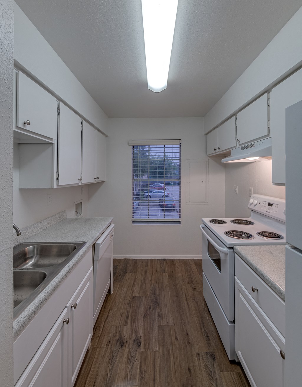 a kitchen with with appliances and white cabinets