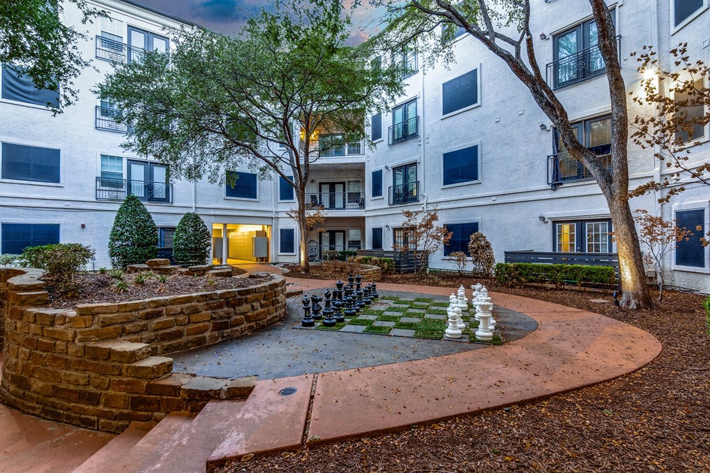 a game of chess in the courtyard of an apartment building