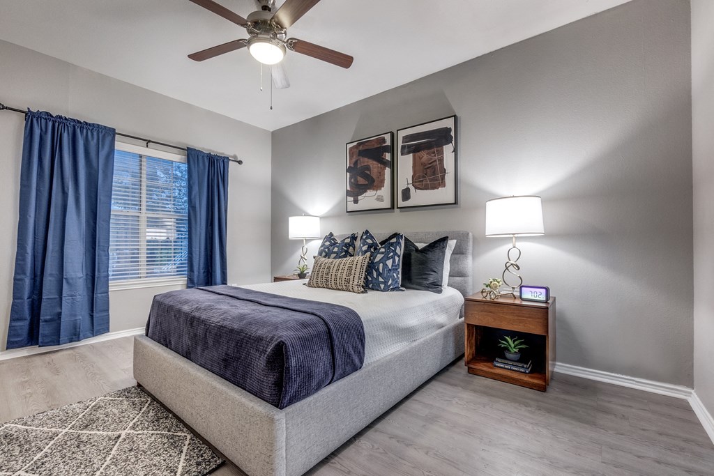 a bedroom with a bed and a ceiling fan