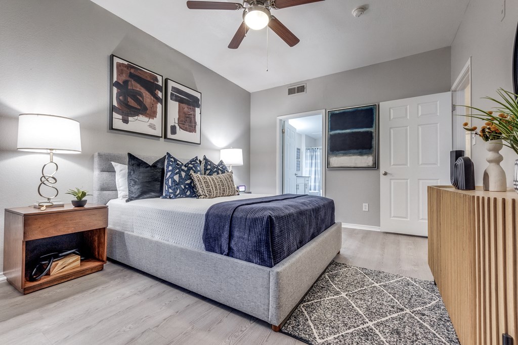 a bedroom with a bed and a ceiling fan