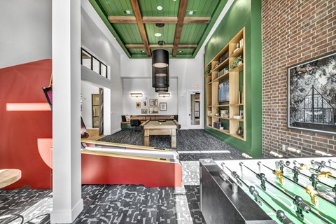 a game room with a pool table and a brick wall