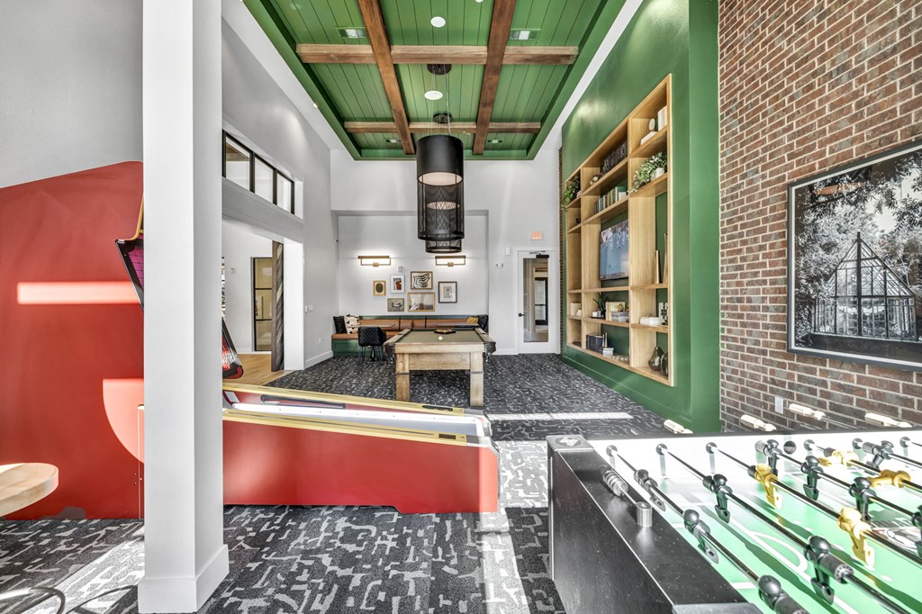 a game room with a pool table and a brick wall