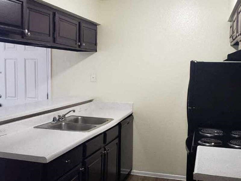a kitchen with a sink and a refrigerator