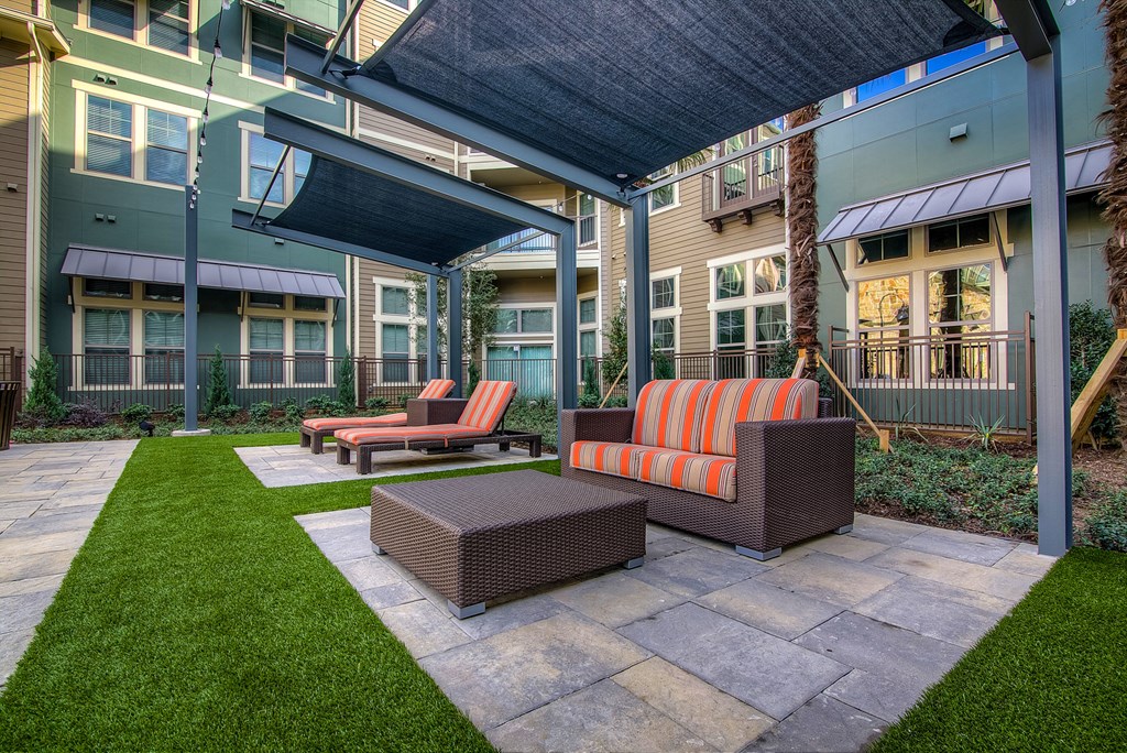 a patio with furniture and awnings at the bradley braddock road station apartments