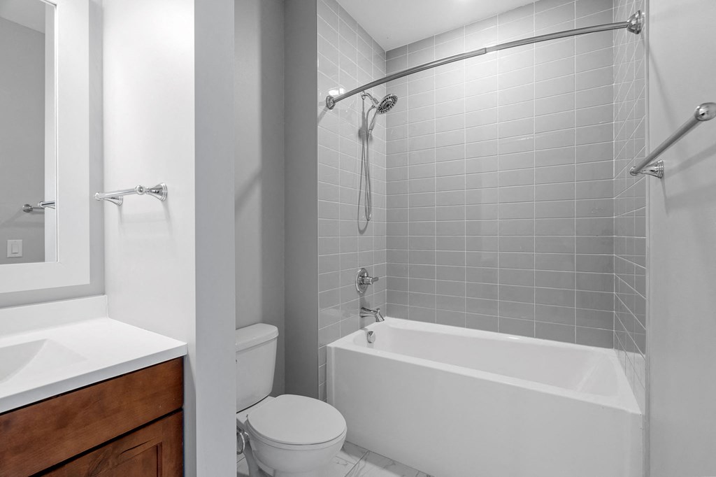 a bathroom with a shower and a toilet and a sink