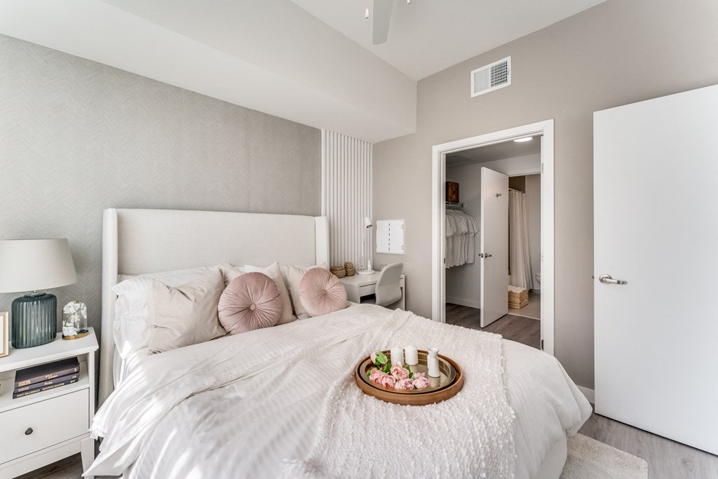 a bedroom with a bed and a tray of food on it