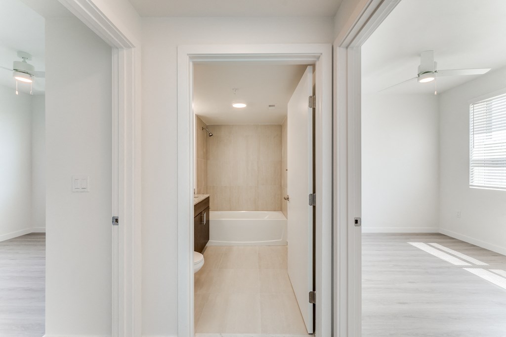 a view of a living room and a bathroom from a doorway