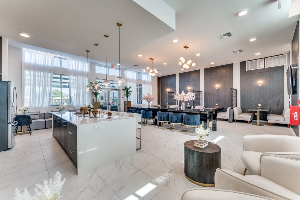 a living room with a table and chairs and a kitchen