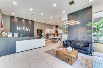 a reception area with a couch and a coffee table and a reception desk