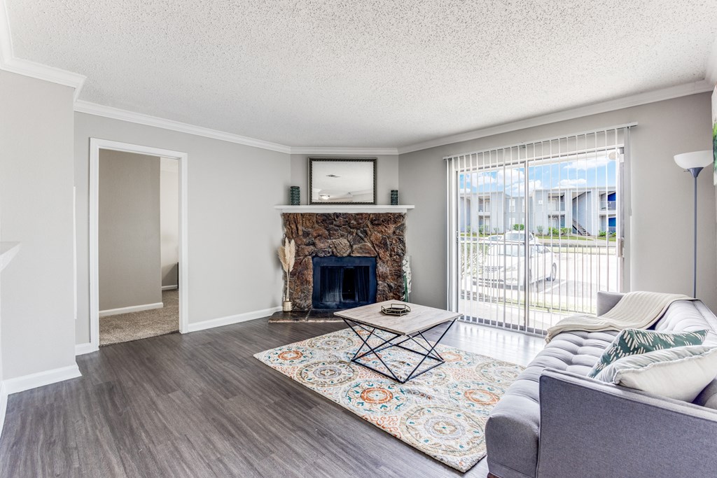 a living room with a fireplace and a sliding glass door