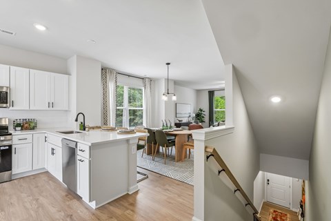 A modern kitchen with white cabinets and a large island.