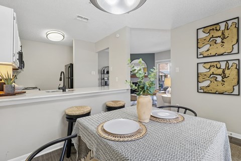A dining room with a table set for two.