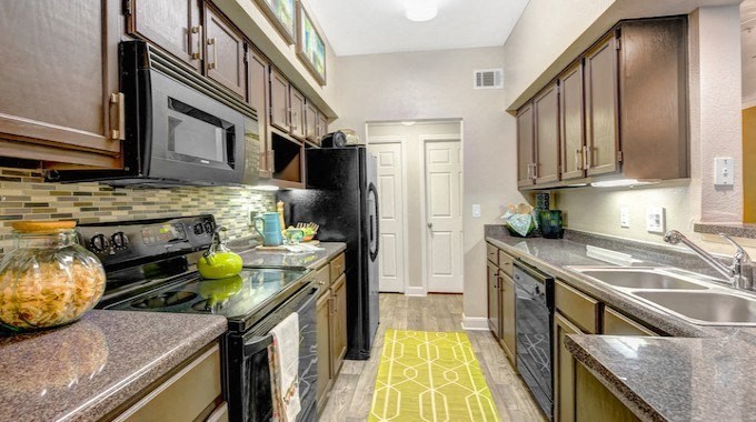 a kitchen with a stove refrigerator and a sink