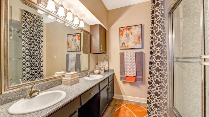 a bathroom with two sinks and a shower