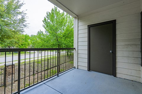 the balcony of a building with a door to a patio
