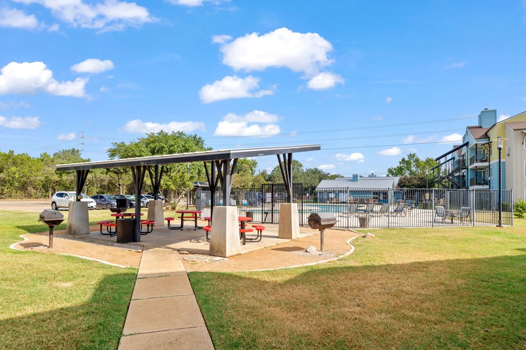 A park with a pavilion and picnic tables.