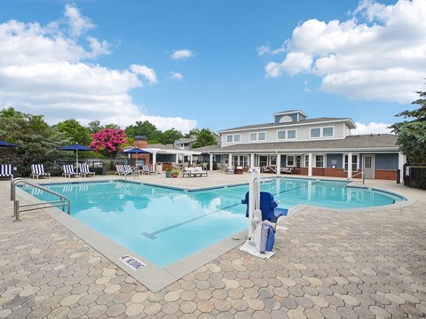 Resort-style swimming pool and outdoor lounge area at Village at Broadstone Station apartments in Apex, NC