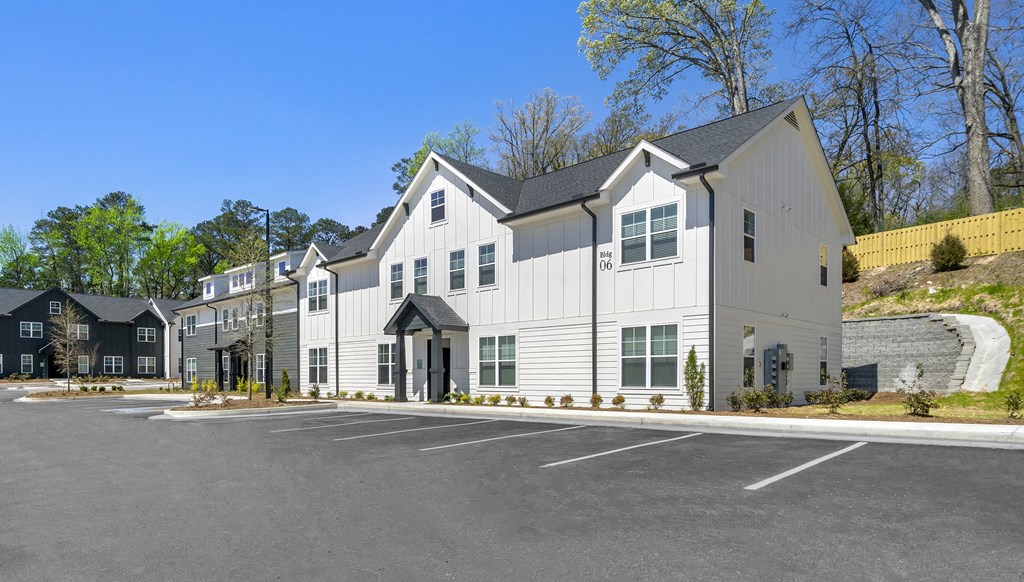 a large white building with a parking lot in front of it
