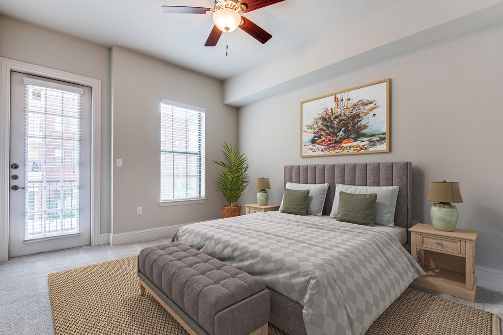 an empty bedroom with a bed and a ceiling fan