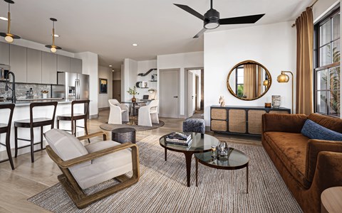 A modern living room with a brown chair and a brown couch.