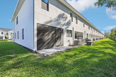 A long white building with a garage door on the side.