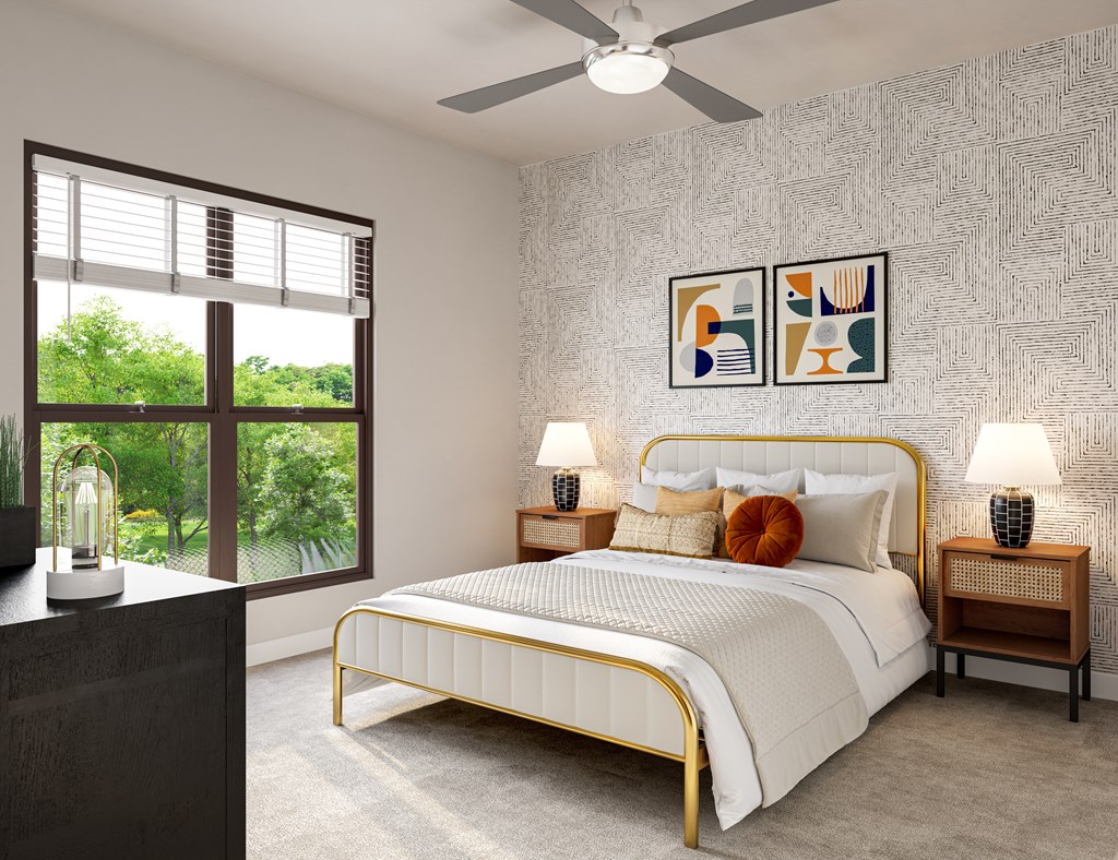 A bedroom with a large bed, a ceiling fan, and a window with blinds.