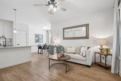 A living room with a white couch and a coffee table.