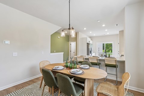 A dining room with a table set for four.