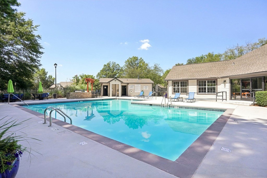 A large swimming pool with a small building next to it.