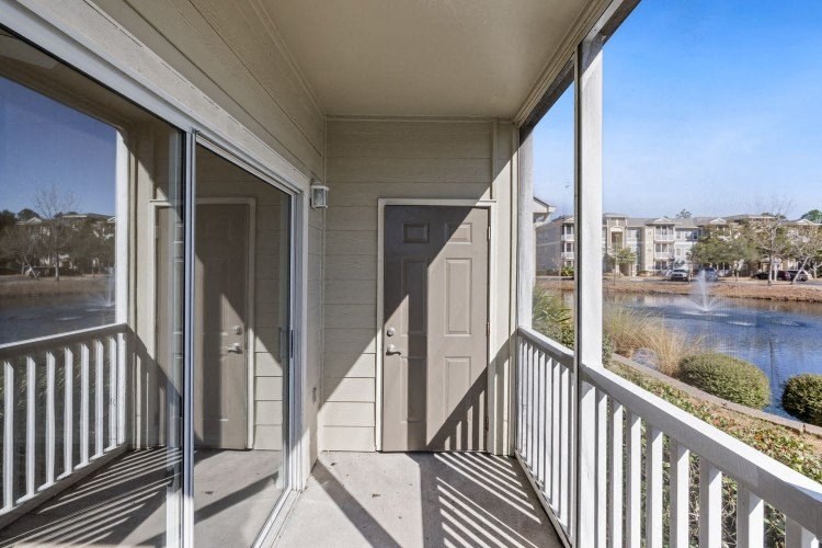 a balcony with a view of a body of water