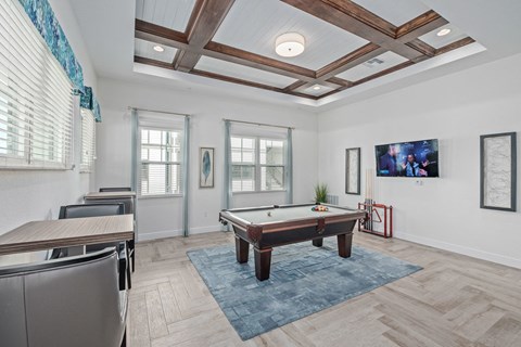 a game room with a pool table and a bar