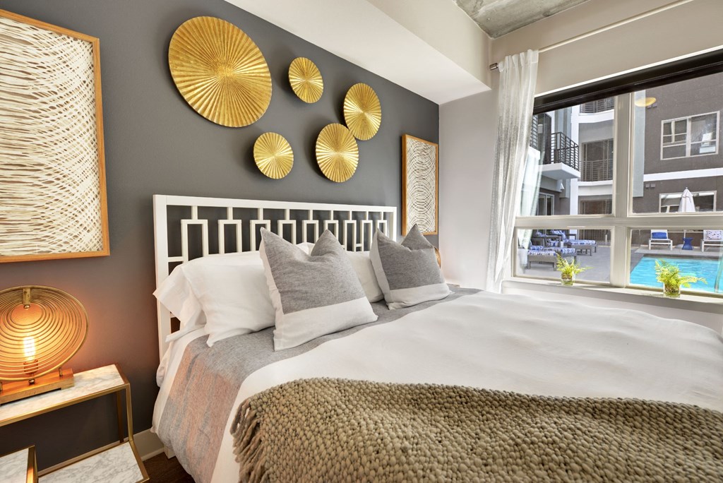 a bedroom with a bed and a window