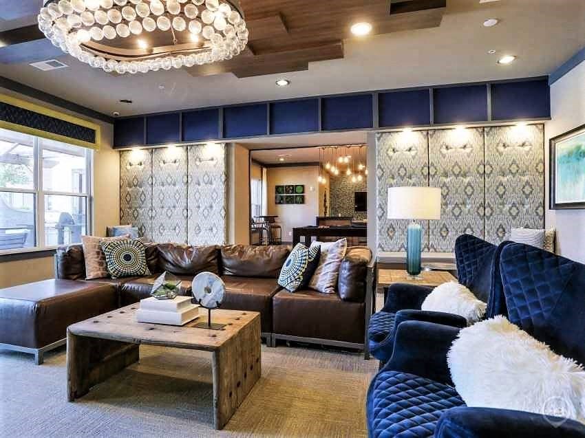 a living room filled with furniture and a chandelier