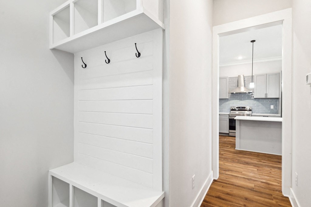 A white kitchen with a white bench and a white cabinet.