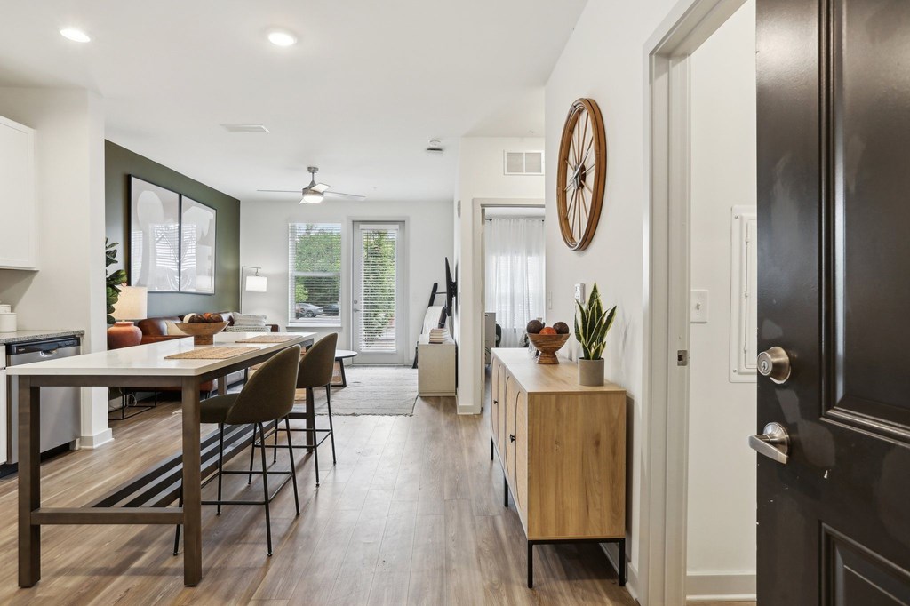 A modern kitchen with a wooden table and chairs.