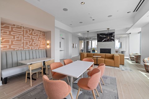 A modern dining room with a white table and chairs.