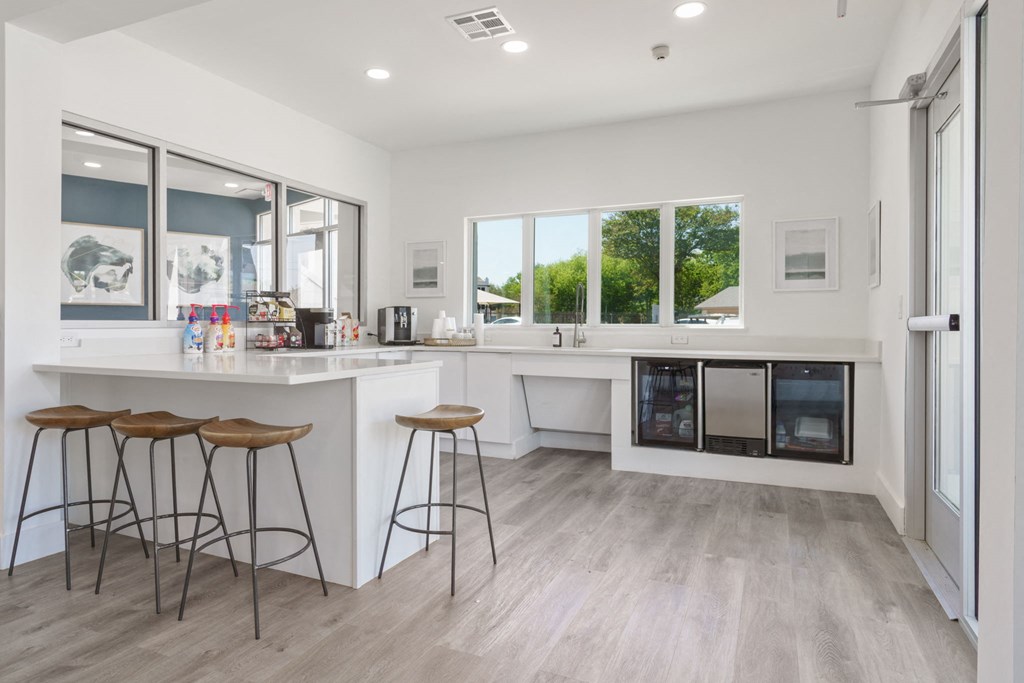 a kitchen with a counter and stools
