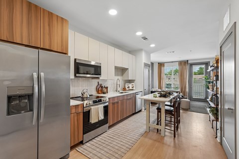 A modern kitchen with wooden cabinets and stainless steel appliances.