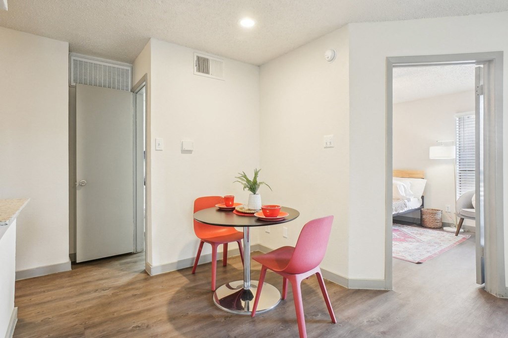 A small dining room with a table and chairs.