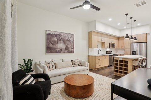 A modern living room with a black chair and a white couch.