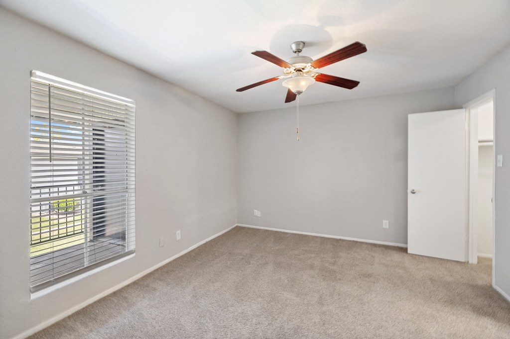 the living room of a house with a ceiling fan