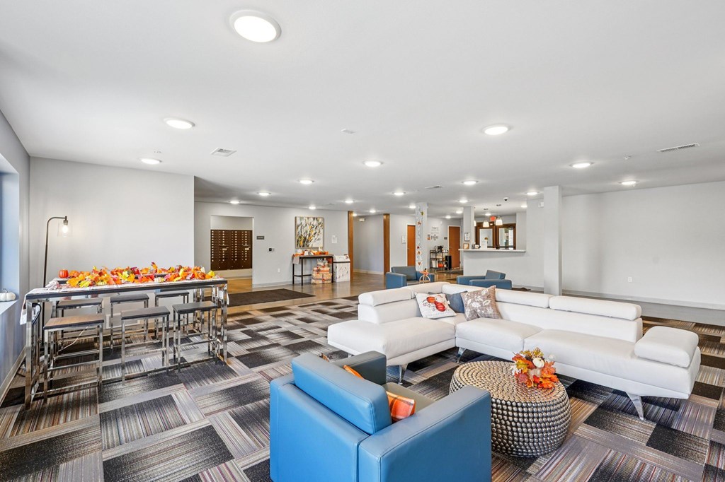 A spacious room with a long table and chairs.