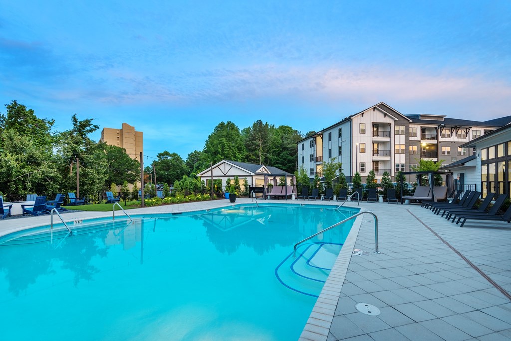 a swimming pool with an apartment building in the background