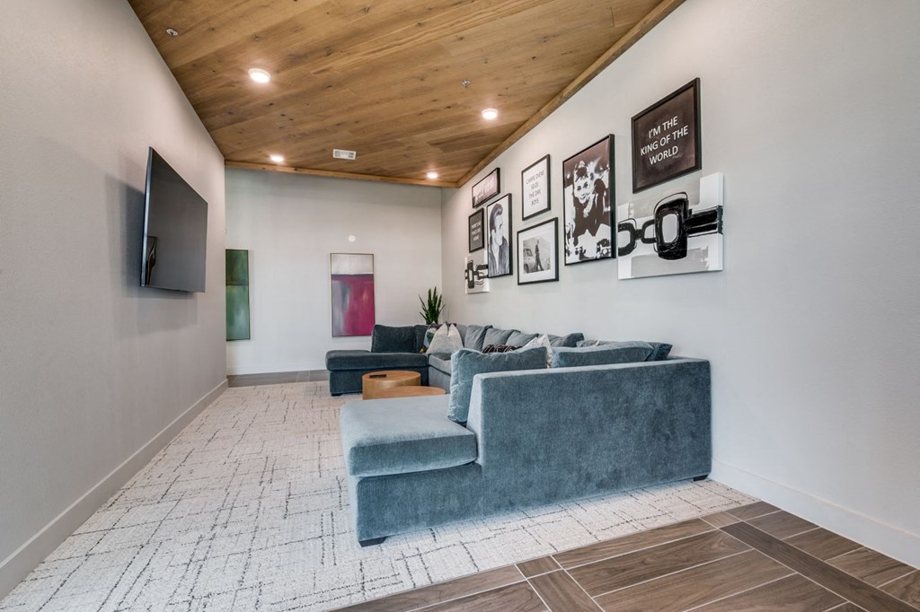 a living room with a blue couch and a tv