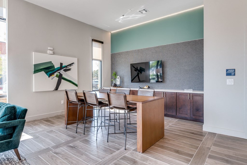 a dining area with a wood table and chairs and a window