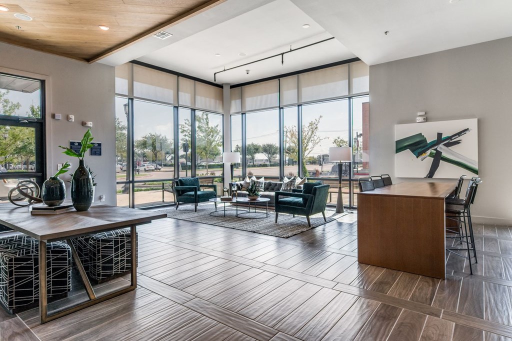 a living room with large windows and a table with chairs