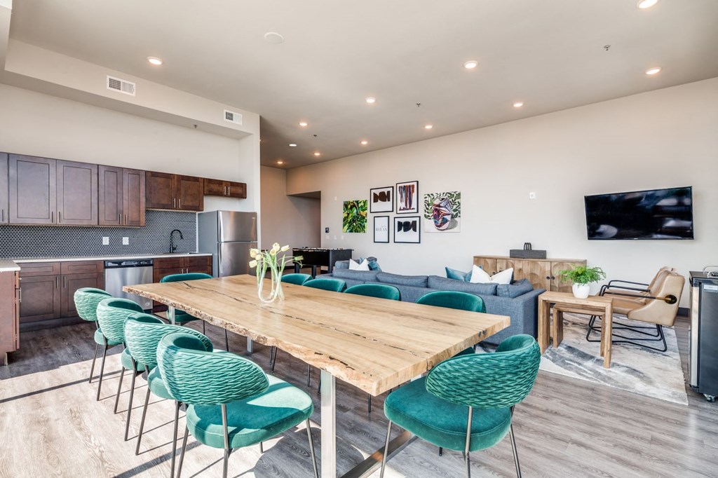 a living room and dining room with a wooden table and chairs