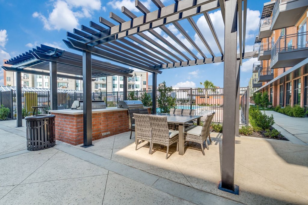 a patio with a table and chairs and a pergola
