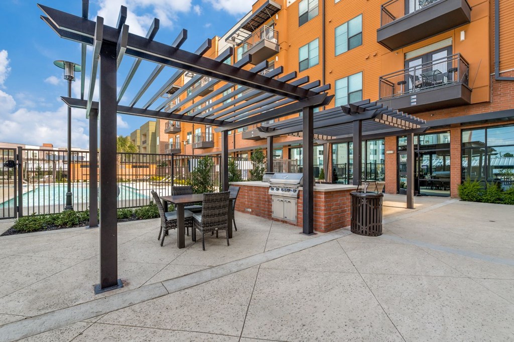 our apartments offer a patio with a grill and a table and chairs